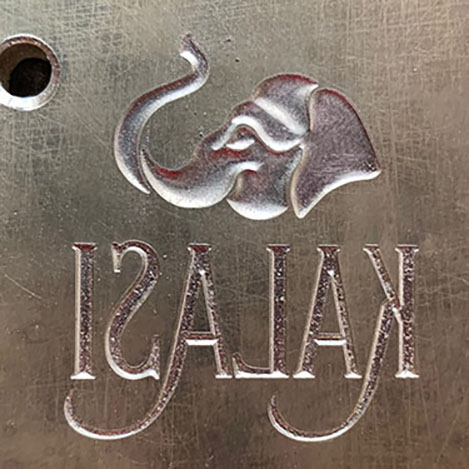 Sculpted multi-level brass emboss die of an Elephant logo and type for a wine label