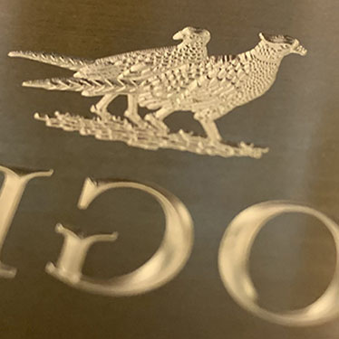 Sculpted multi-level brass emboss die of two detailed pheasants and type for a wine label