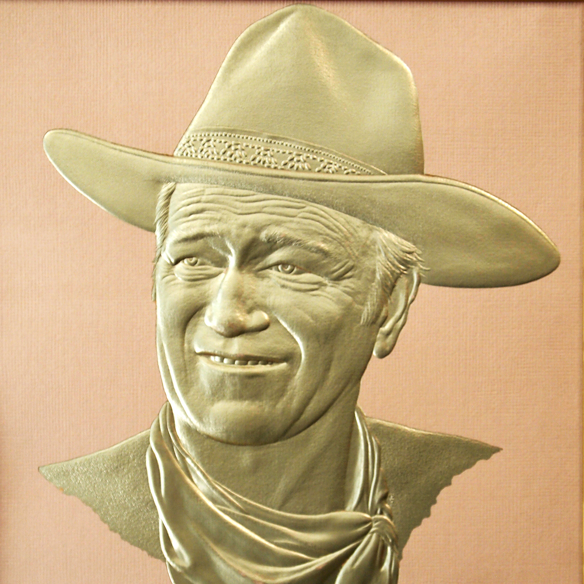 Sculpted multi-level emboss of a cowboy registered to foil on thick paper stock